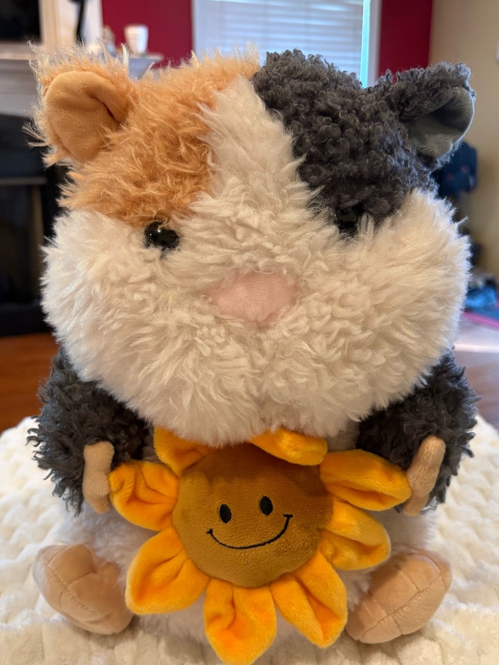 24” Russ sunflower cuddle Guinea Pig Plush holding a small yellow sunflower